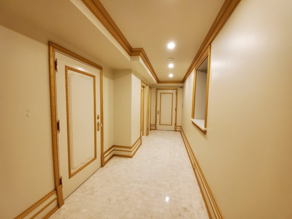Basement with custom wood accents by Andrea D'Alessio